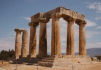 a large stone structure sitting on top of a dirt field
