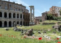 brown concrete building near green grass field during daytime