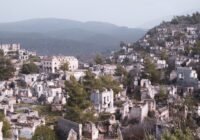 white and brown concrete houses on mountain during daytime