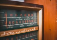 brown wooden framed red and black cd rack