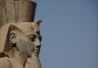 a close up of a statue of an egyptian god