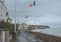a street with flags on a cloudy day