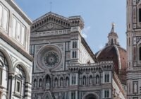 a large cathedral with a clock on it's side