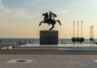 a statue of a man riding a horse near the ocean