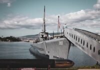 grey warship on dock during daytime