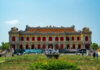 A majestic building stands in the sunny landscape
